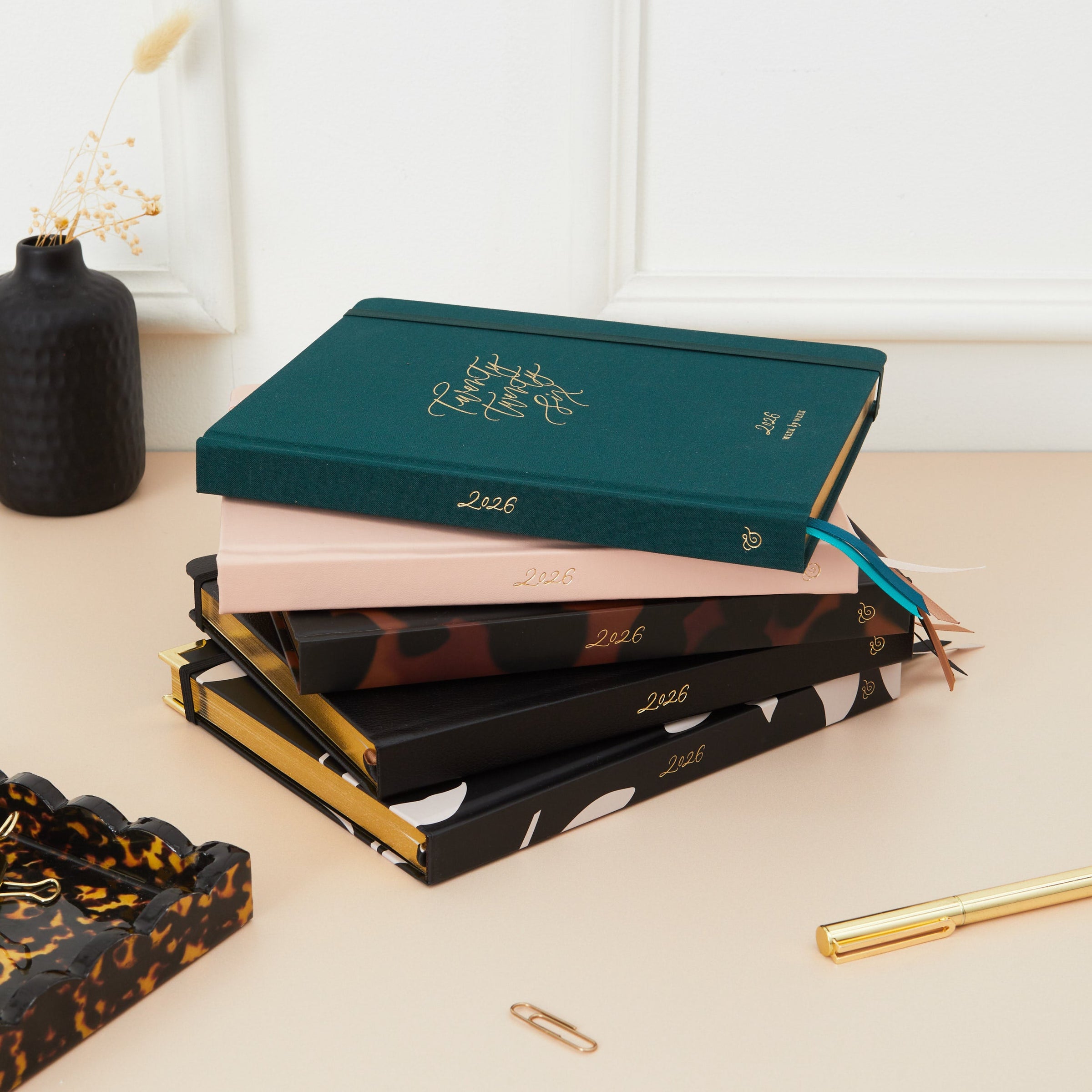 Collection of 2026 weekly diaries featuring sleek covers, each displayed with a presentation box. Weekly layouts show equal space for each day and time-blocking sections for organised scheduling.