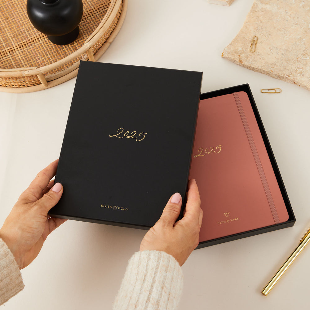 2025 weekly planner in clay vegan leather with gold details, providing equal space for each day’s time-blocking, to-do lists, notes, and monthly goals and budget pages.