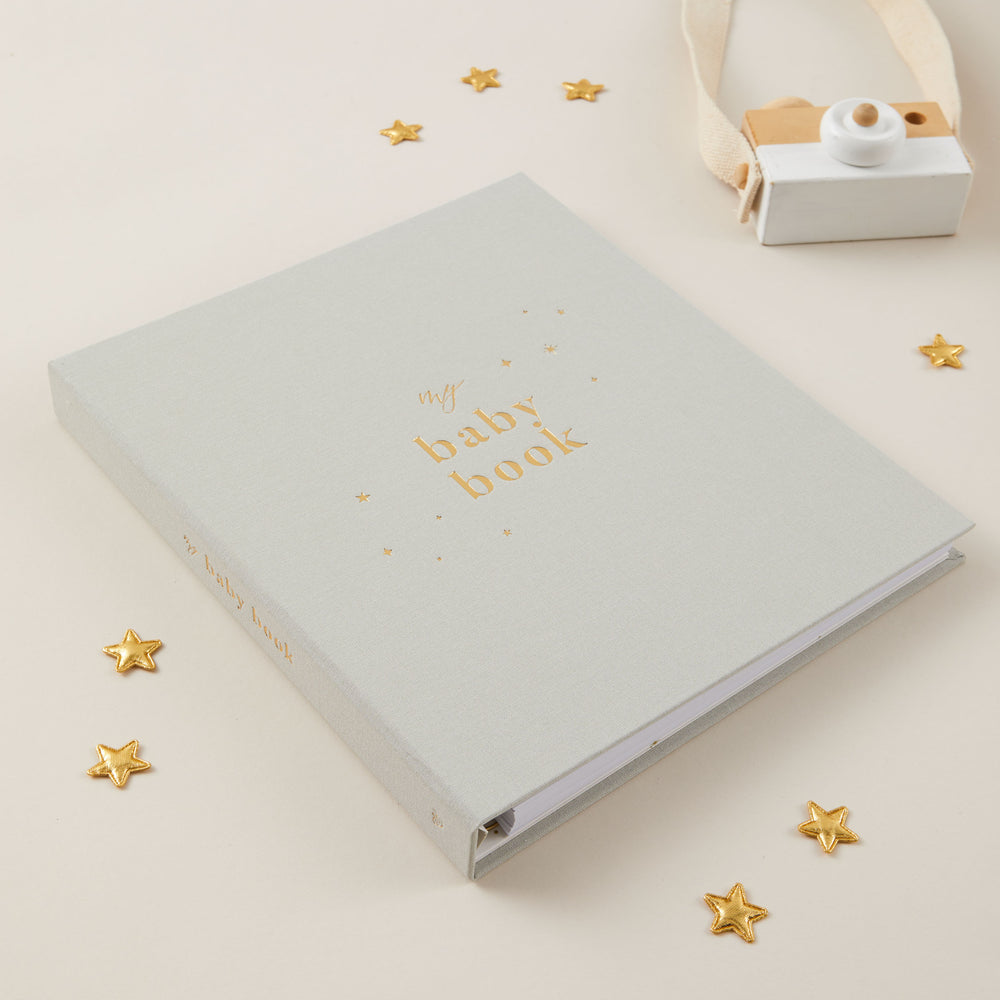 Open baby record book 5 years showing milestone pages