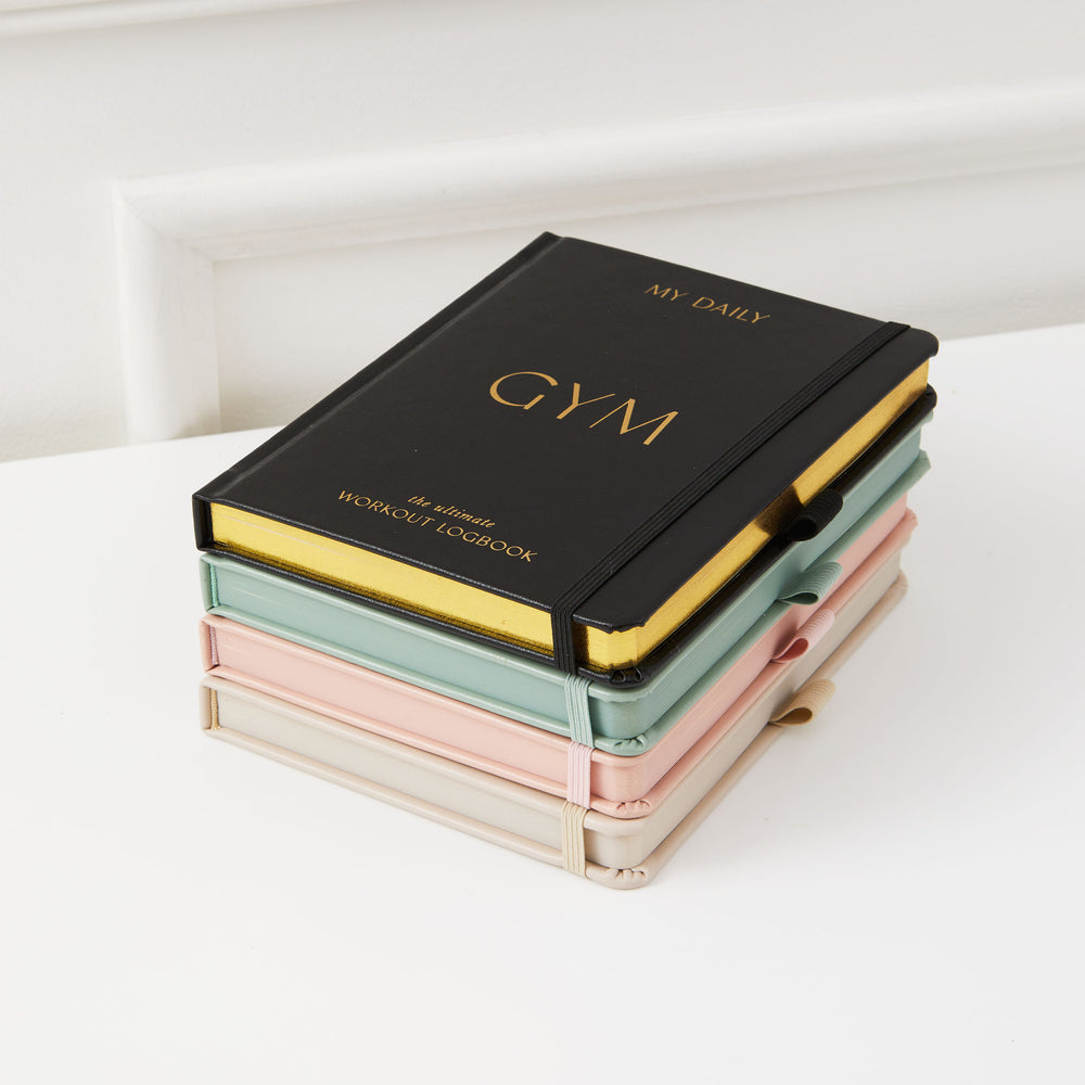 Sleek black fitness tracker and progress journal