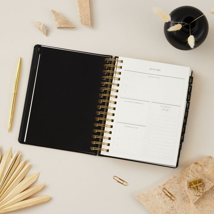 2025 daily diary with monthly pages, gratitude list, goals, and to-do list sections for comprehensive planning and reflection.