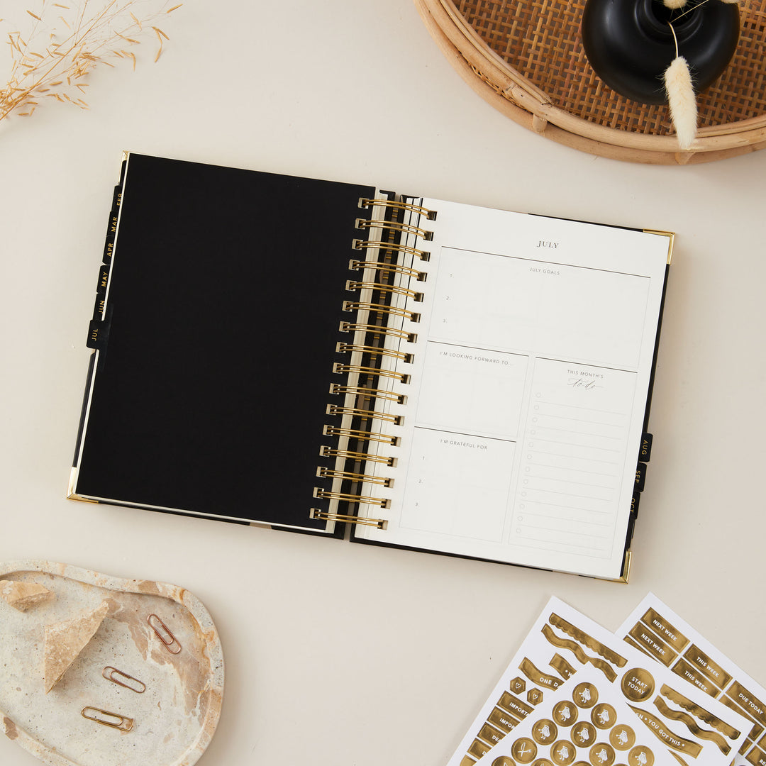 2025 daily planner featuring monthly introduction pages, including sections for to-do lists, gratitude reflections, and goal setting, offering a comprehensive and organised approach to planning each month.