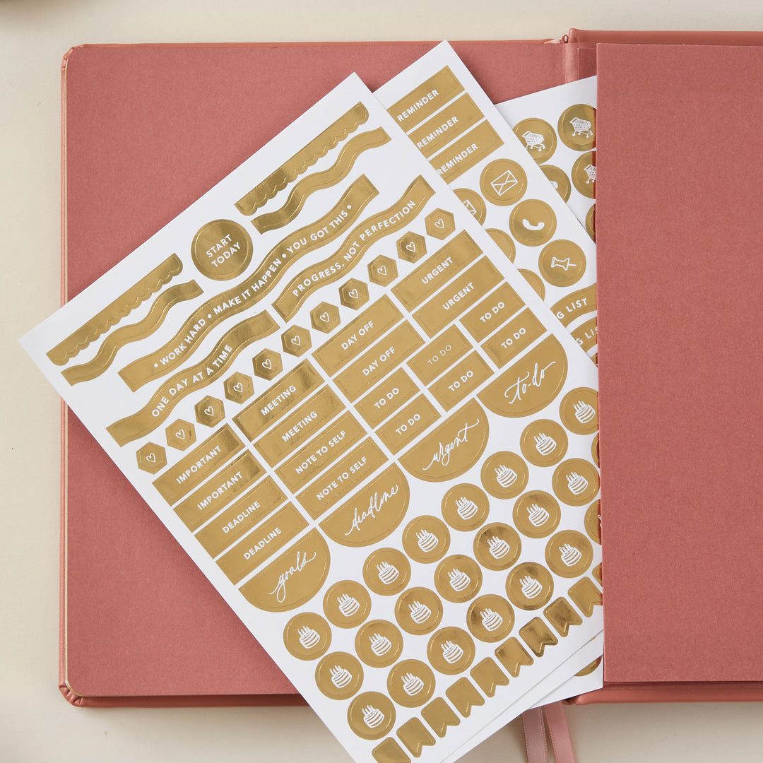 2025 planner with a clay vegan leather cover and gold details, offering weekly time-blocking, to-do lists, space for notes, and pages for tracking monthly goals and budgets.