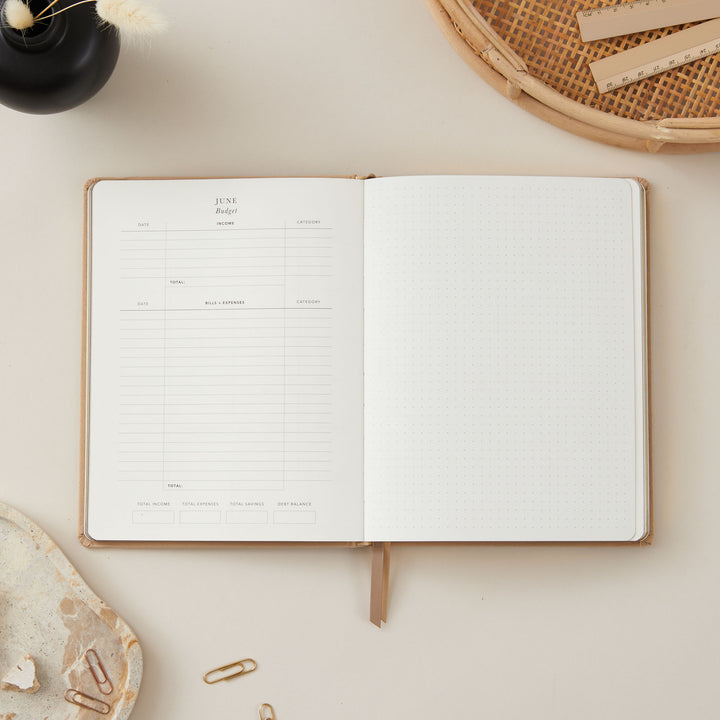 2025 planner in ivory fabric with gold details, featuring weekly time-blocking with equal space for each day, to-do lists, and monthly goal-setting and budgeting pages.