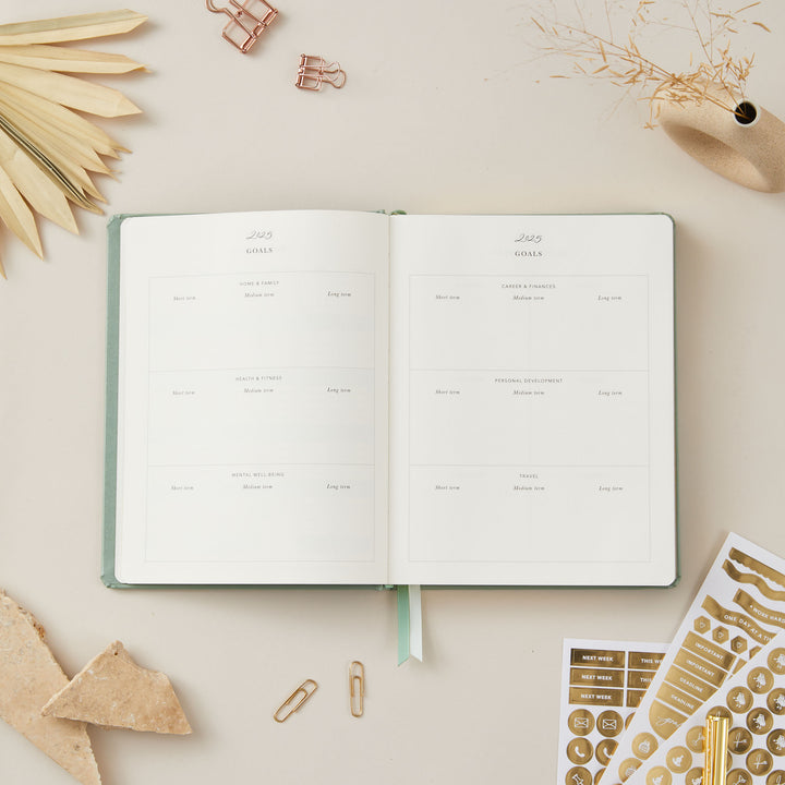 2025 planner in sage green vegan leather with gold details, offering equal space for time-blocking, to-do lists, and pages for monthly goals and budgeting.