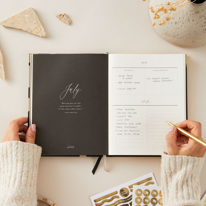 2025 planner with a minimalist floral design and gold foil cover, featuring week-to-view layouts with time blocking, to-do lists, note space, and monthly goals and budget pages.