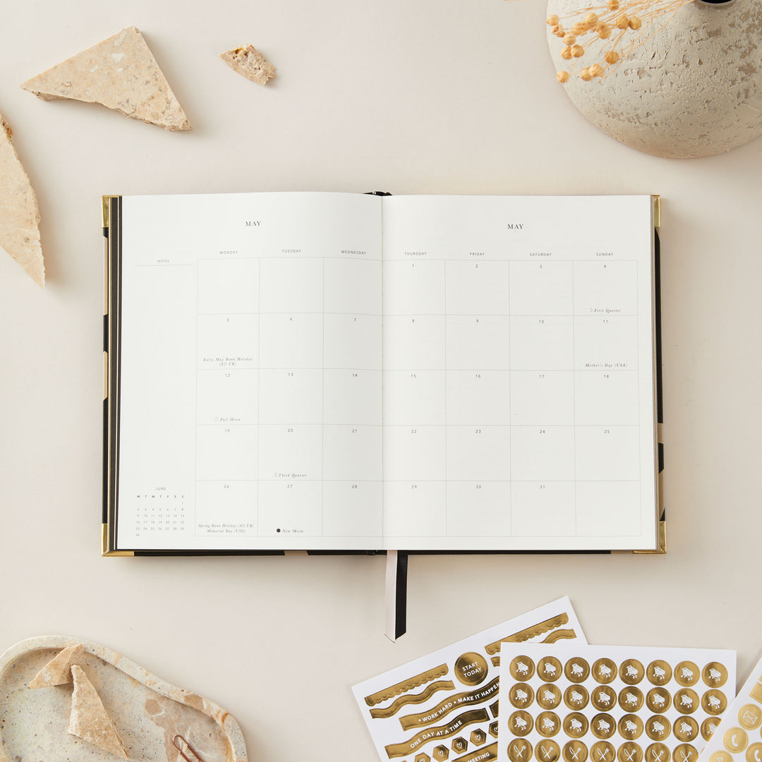 Minimalist 2025 weekly planner with floral details and a gold foil cover, featuring time-blocking, to-do lists, and monthly goals and budget pages.