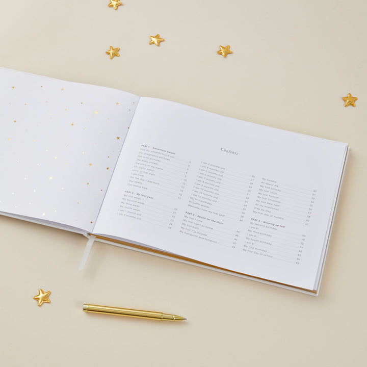 Contents page of a baby memory book listing various sections and chapters, decorated with soft pastel illustrations of foiled gold stars.