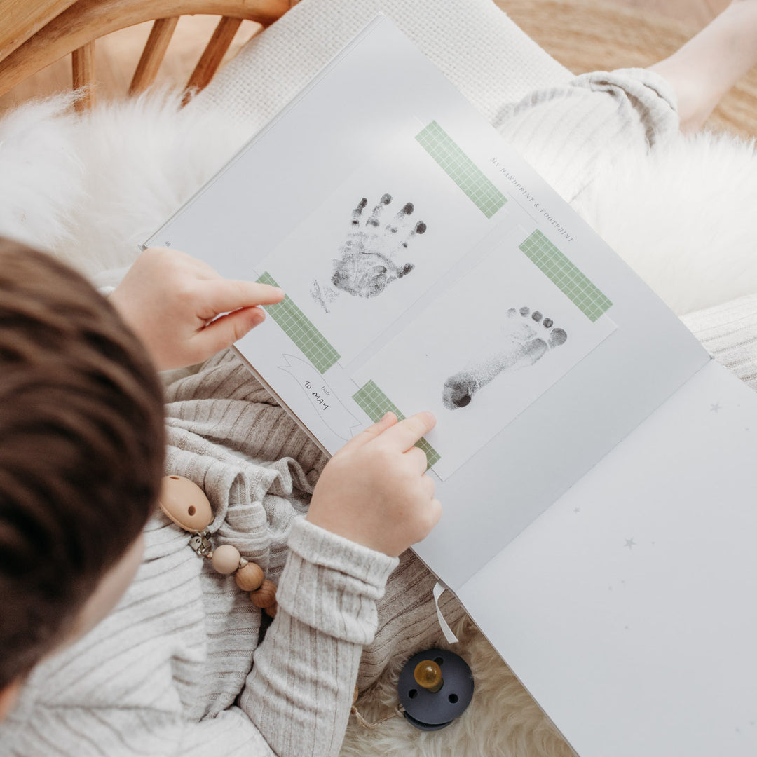 Page dedicated to baby's handprints and footprints.