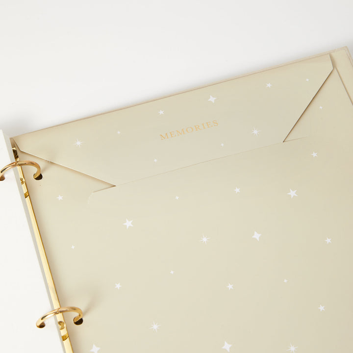 Baby memory book featuring a foiled envelope for storing keepsakes, perfect for preserving precious moments and milestones.