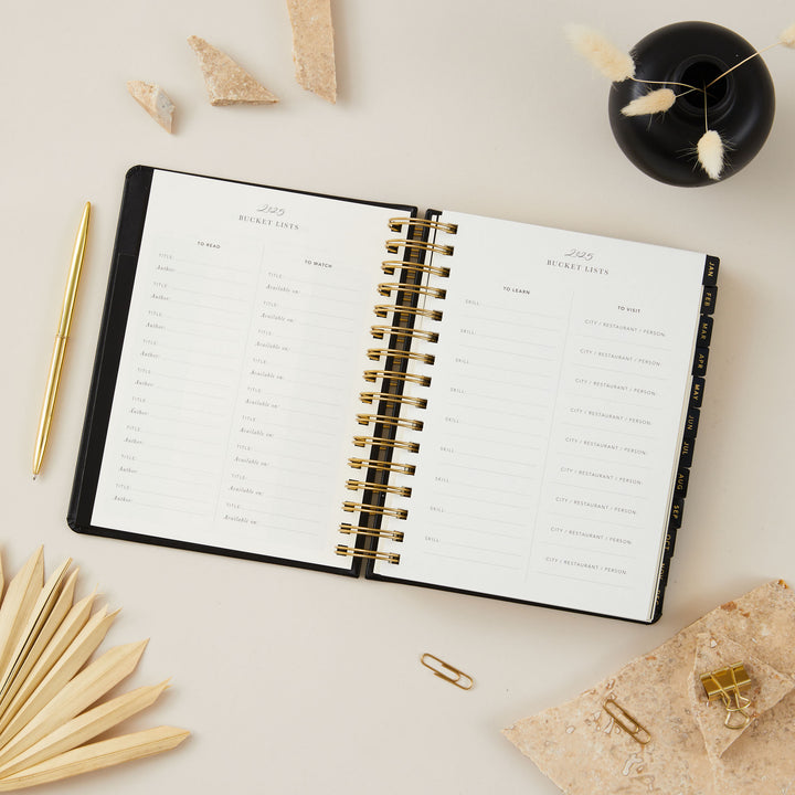 Luxurious black vegan leather 2025 daily diary with stunning gold foil accents, perfect for practical and stylish organisation.