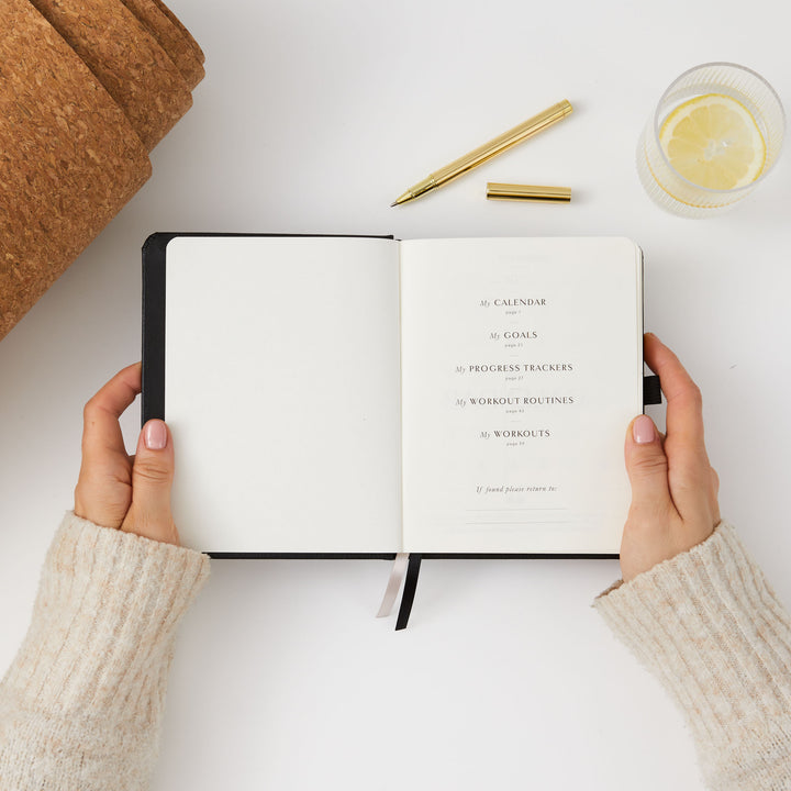 Black fitness journal for setting and tracking fitness goals