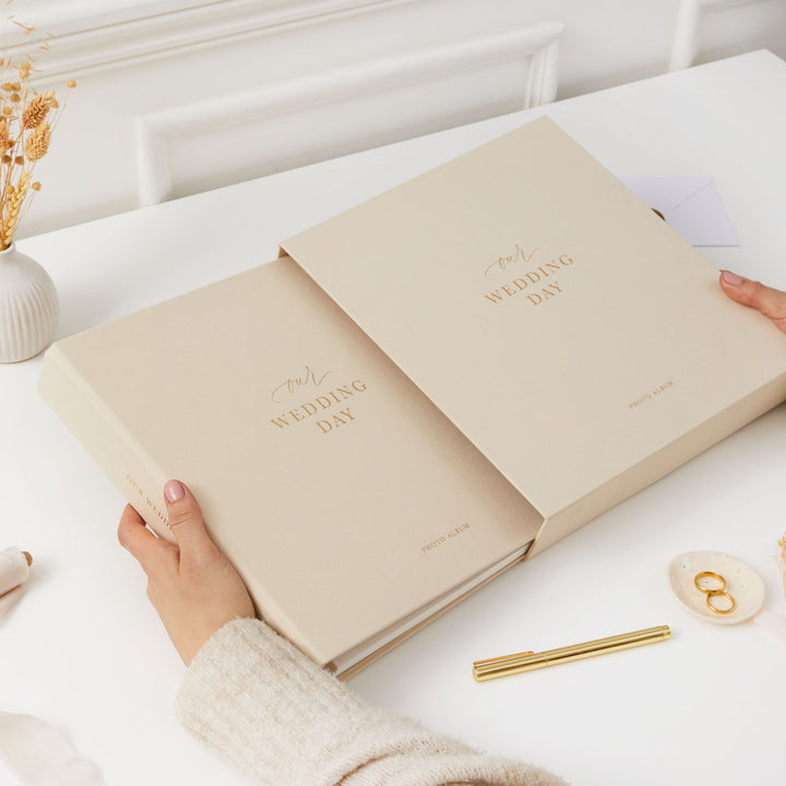 Blank wedding photo album with an ivory cover, gold details, and ivory pages, a thoughtful gift for newlyweds.