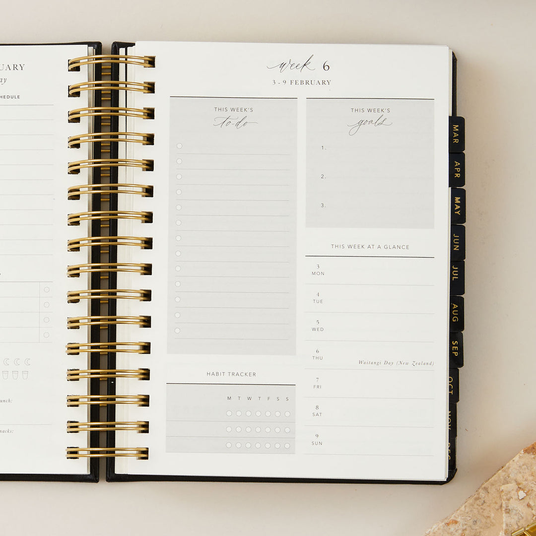 2025 daily diary with a sleek black vegan leather cover and gold foil accents, offering a stylish and functional design.