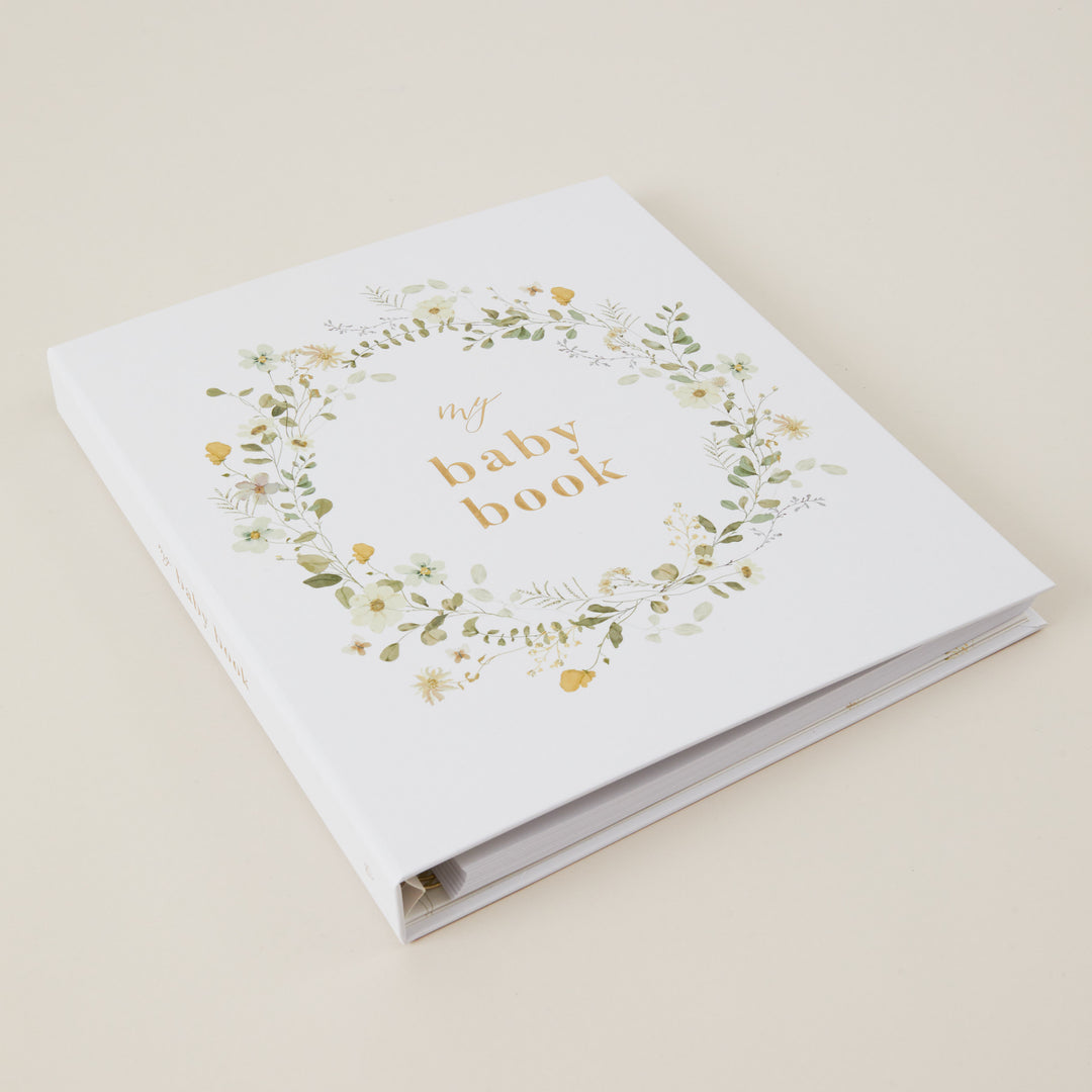 Beautiful floral baby record book with gold foiled details, cloth cover design, and gender-neutral pages for newborn memories.