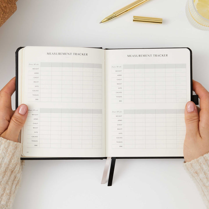 Compact black workout planner for tracking sets and reps