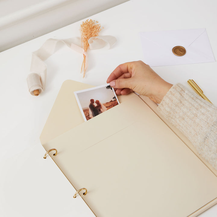 Elegant photo album for weddings, featuring a cloth ivory cover, gold accents, and a matching slipcase for protection.