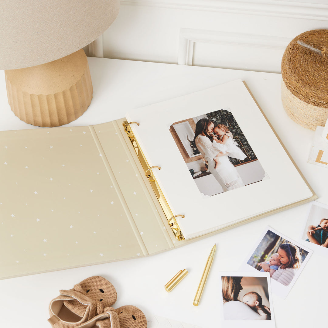 First-year photo album with gold foiled details and delightful animal illustrations, ideal for capturing and cherishing baby's milestone moments.