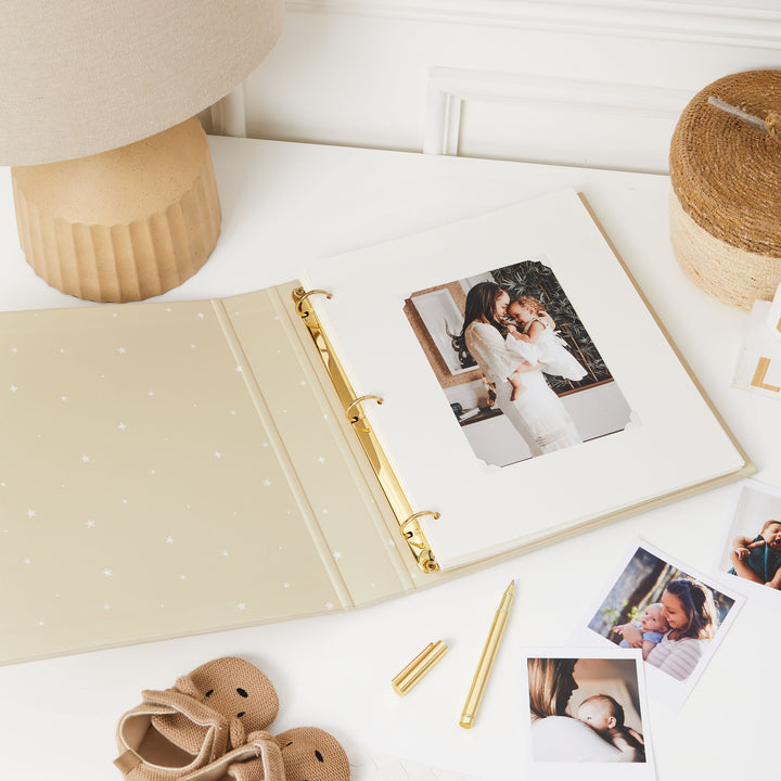 First-year photo album with gold foiled details and delightful animal illustrations, ideal for capturing and cherishing baby's milestone moments.
