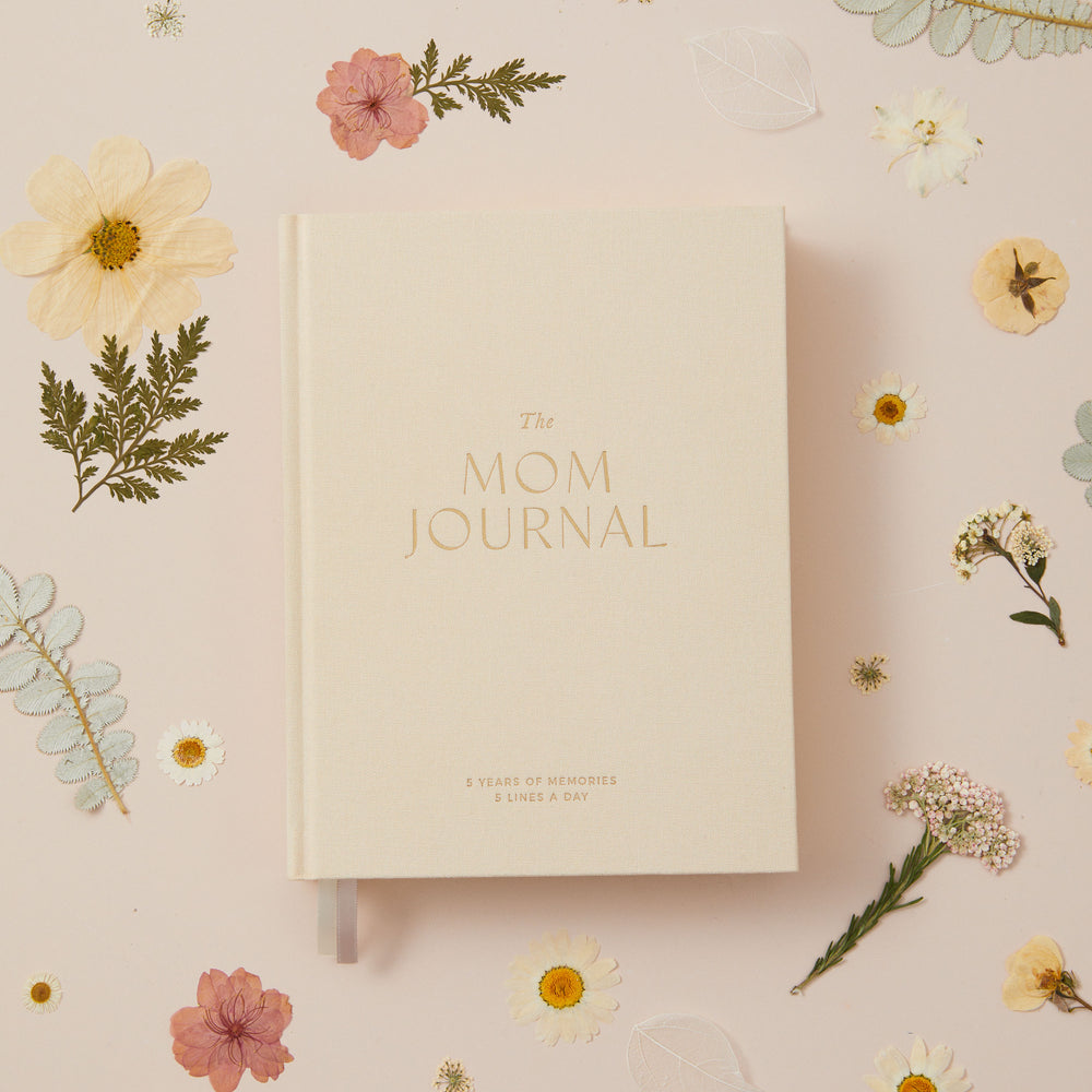 Five year mom journal with ivory cloth cover designed to capture the same day across five years