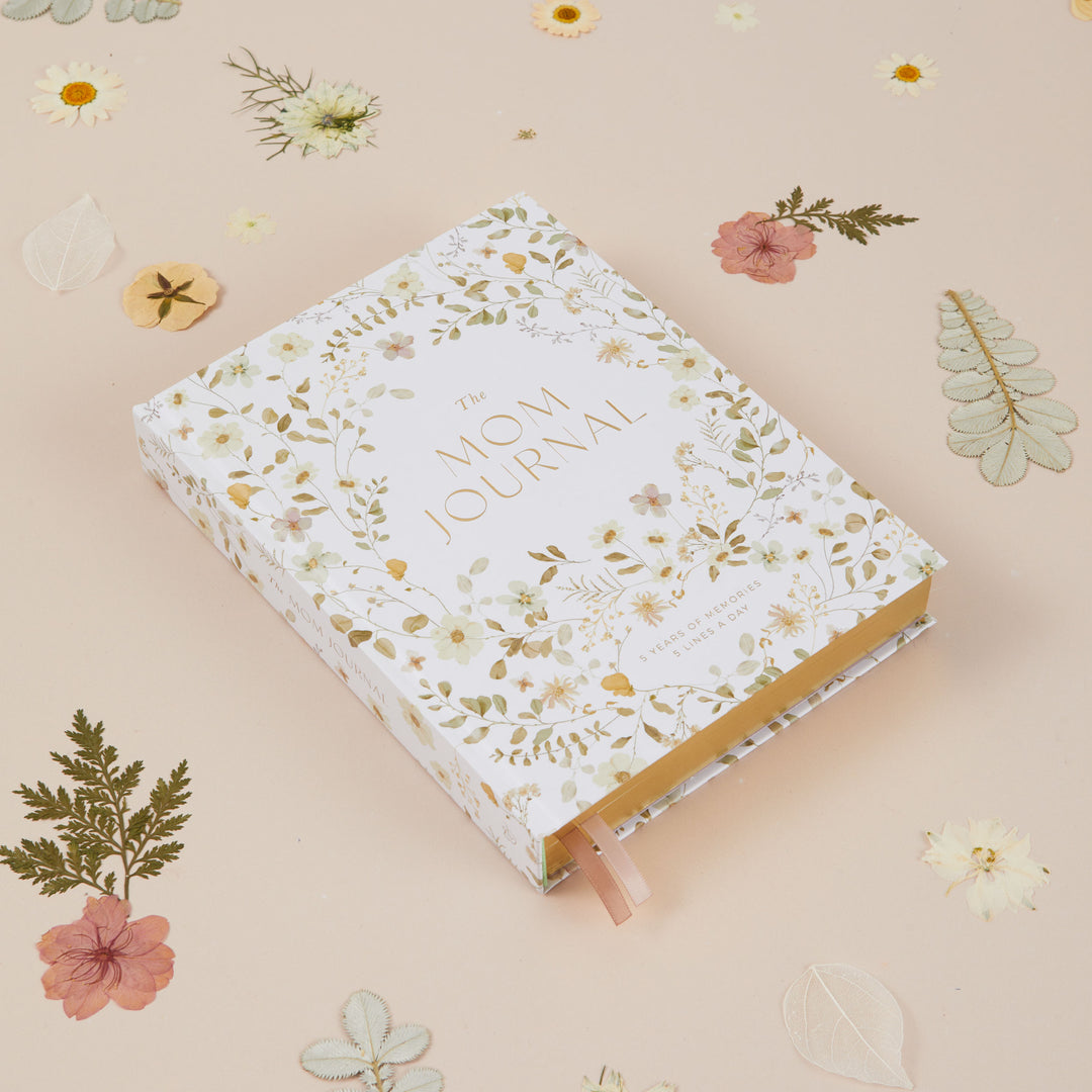 Motherhood memory journal with wildflower illustrations created to record five years of family memories