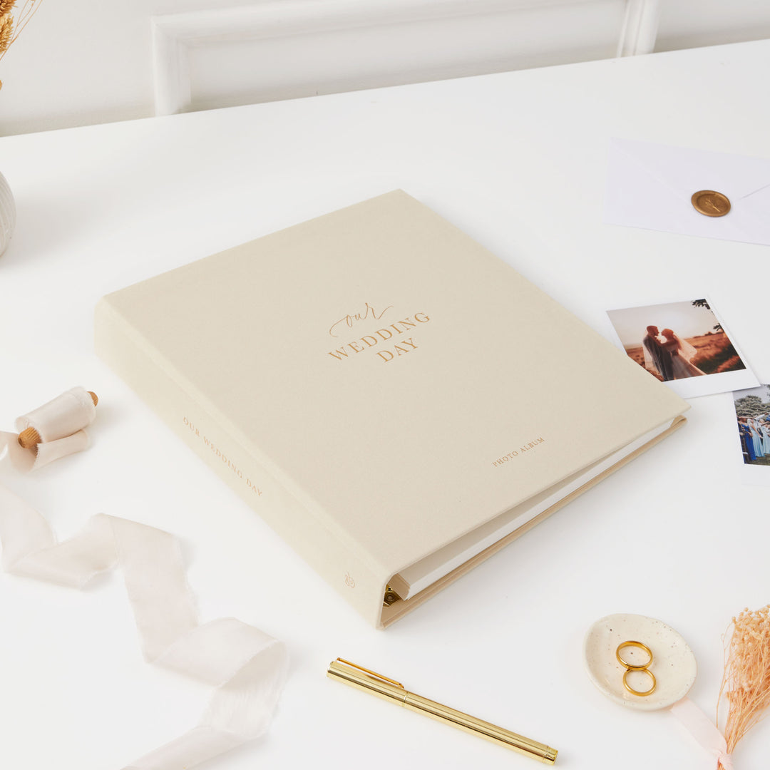 Luxurious ivory and gold wedding photo album with blank pages and a matching cloth slipcase, ideal for preserving special moments.