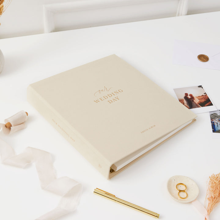Luxurious ivory and gold wedding photo album with blank pages and a matching cloth slipcase, ideal for preserving special moments.