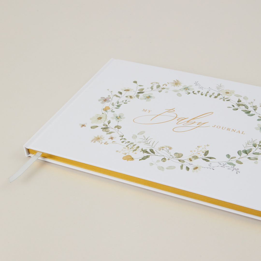 Journal with floral design and 'Daily Journal' text on a beige background