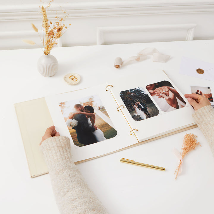Luxury wedding photo album with a cloth ivory cover, matching slipcase, and blank ivory pages for treasured memories.