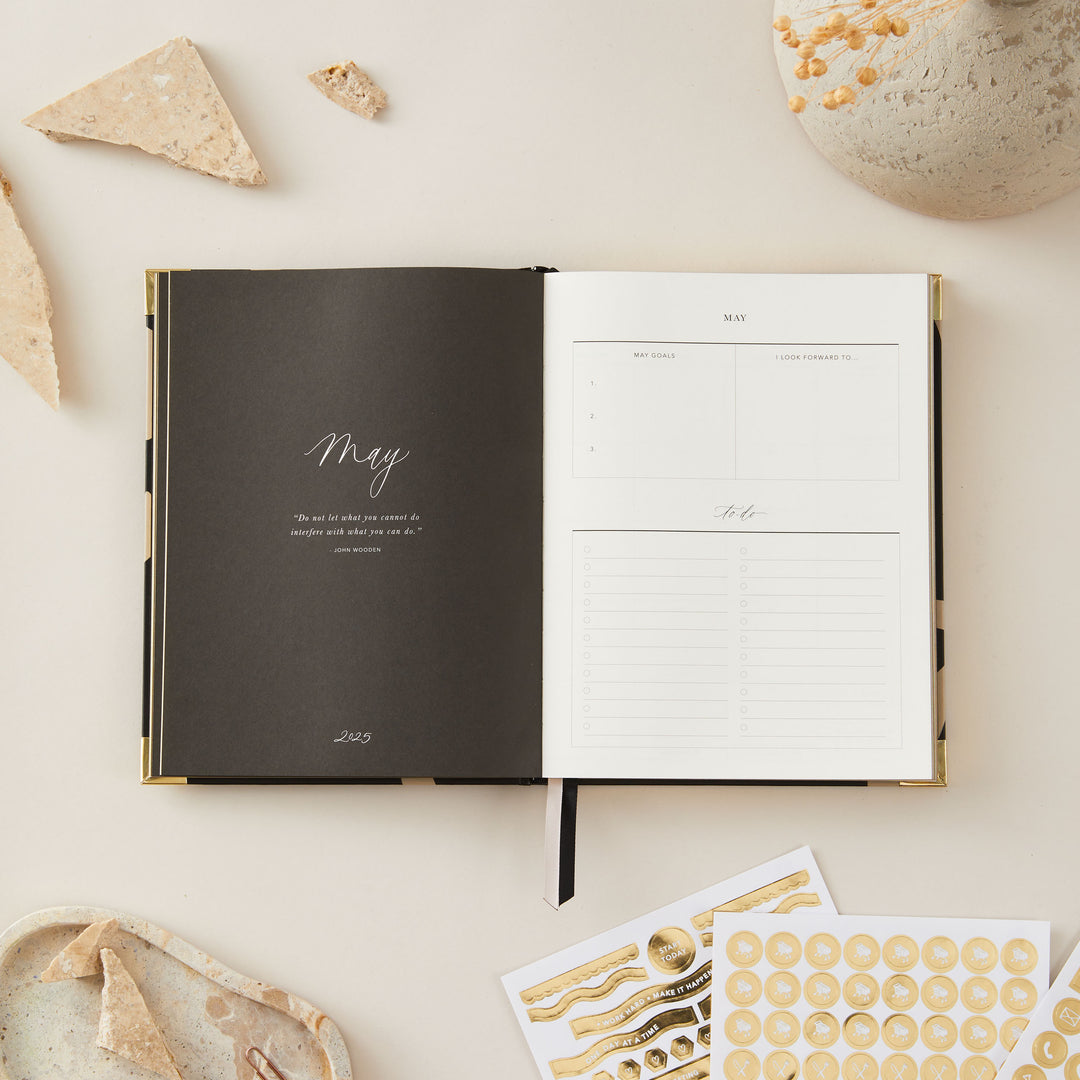 Floral-themed 2025 weekly planner with a minimalist design, gold foil cover, and gold edging, including weekly time-blocking, to-do lists, and monthly goal pages.