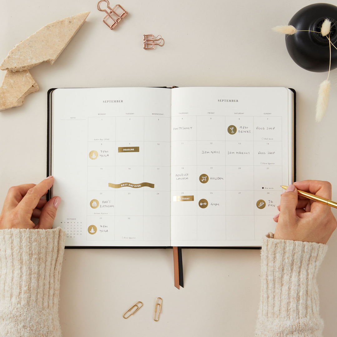 A 2025 weekly planner open to a spread, featuring both weekly and monthly planning pages with a clean and organised layout.