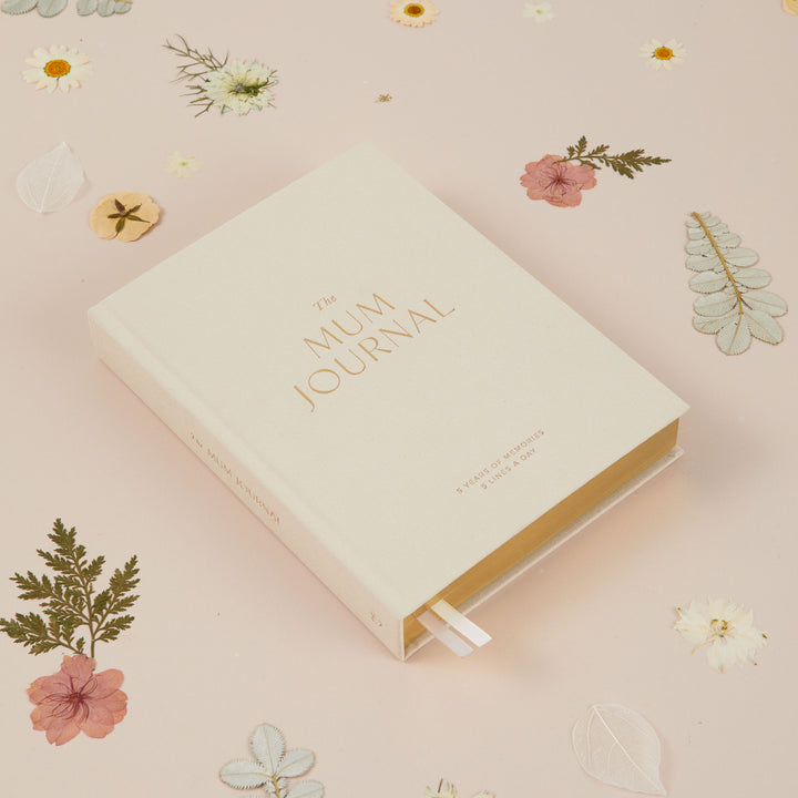Flat lay of ivory cloth mum journal highlighting premium fabric cover and simple design