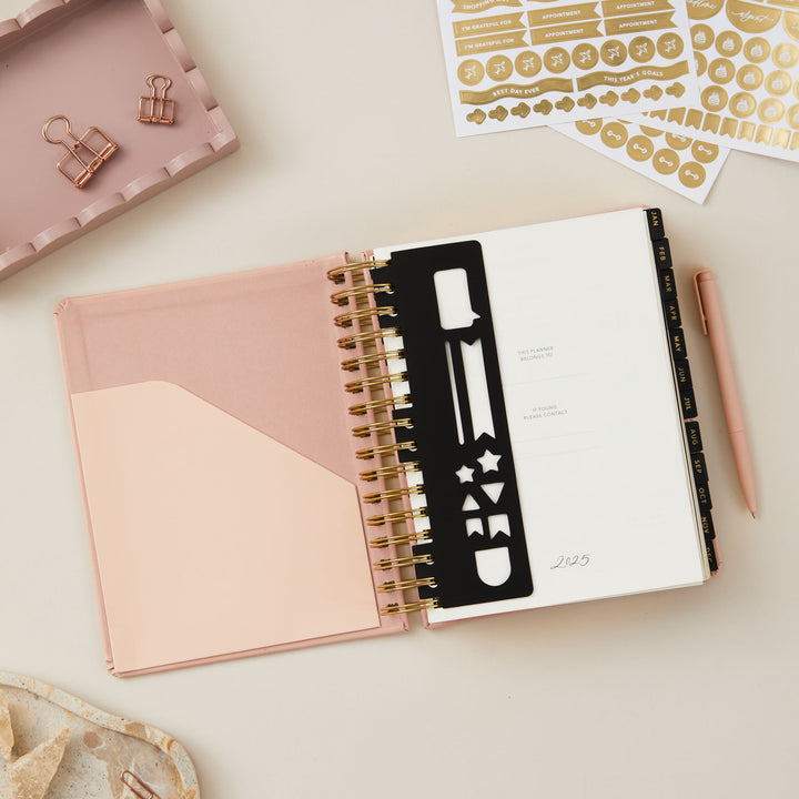 Pink day-to-page 2025 ring-bound planner with a removable bookmark for convenient page marking and easy access.
