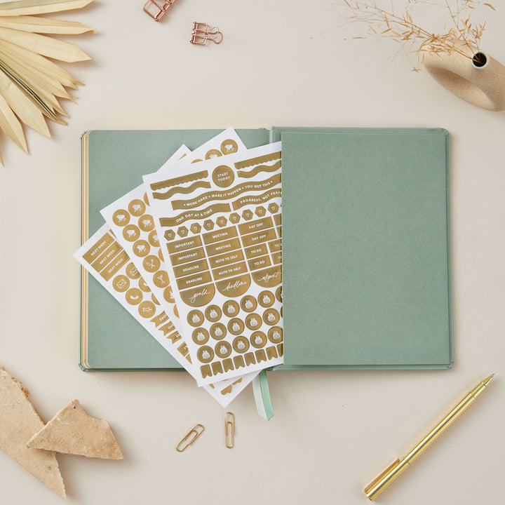 Sage green vegan leather 2025 weekly planner with gold accents, providing equal space for daily time-blocking, to-do lists, note pages, and monthly goals and budgeting.