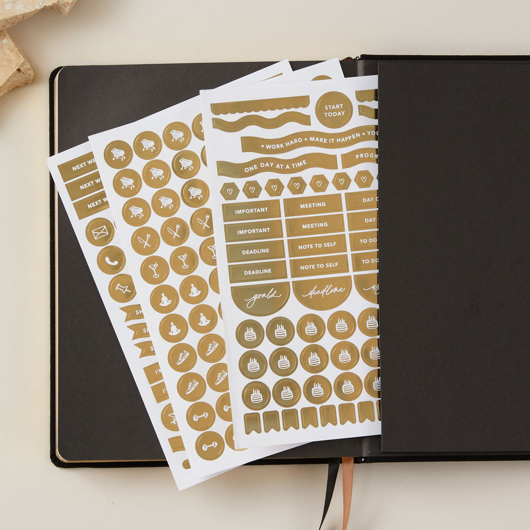 Soft black vegan leather 2025 weekly planner with gold details, designed with time-blocking for each day, to-do lists, note space, and sections for monthly goals and budgeting.