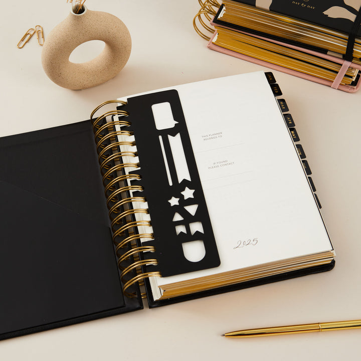 Stylish black vegan leather 2025 daily diary featuring gold foil accents on the cover, combining practicality with elegance.