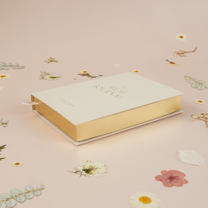 Undated mum journal in ivory cloth with space to write the date and record memories over five years