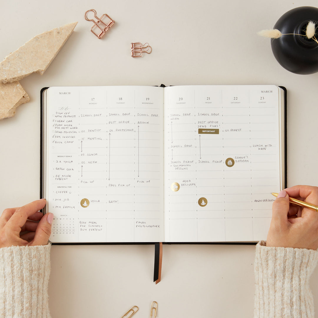 Soft black vegan leather 2025 planner with gold details, providing equal space for daily time-blocking, to-do lists, note pages, and monthly goals and budgeting.
