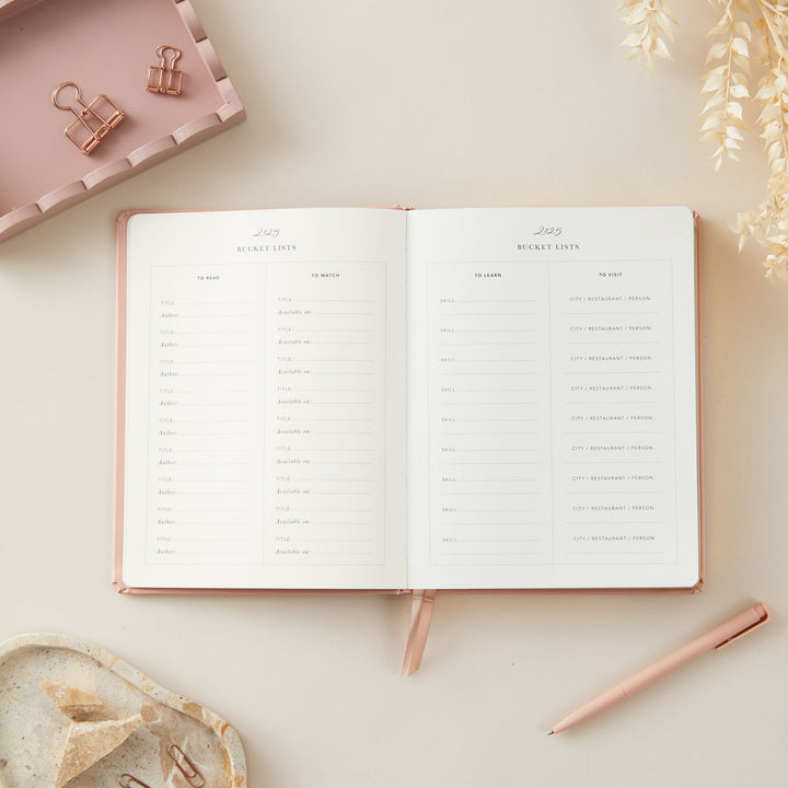 Chic soft pink vegan leather 2025 weekly planner with gold accents, featuring time-blocking layouts, to-do lists, and monthly goal and budget tracking sections.