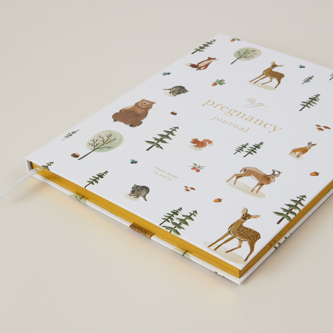 Pregnancy journal with nature-themed design on a beige background