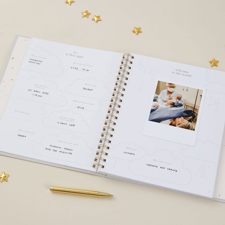 Flat lay of baby record book 5 years with baby accessories