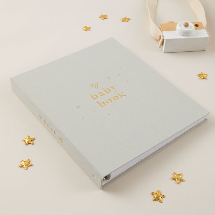 Open baby record book 5 years showing milestone pages