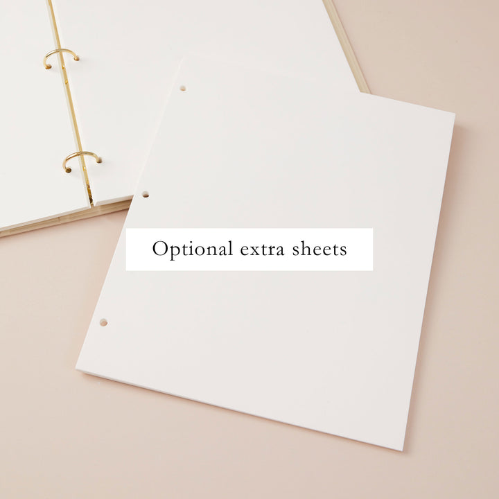 Beautifully designed blank wedding photo album with a cloth ivory cover, gold accents, and a matching slipcase.