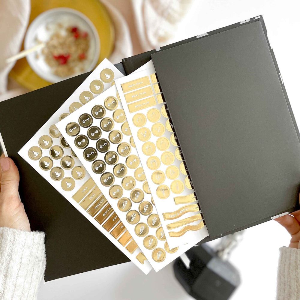 Flat lay of daily workout planner with gym gear and headphones
