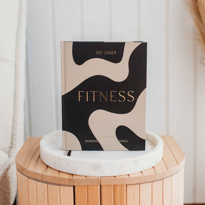 Fitness enthusiast planning week with daily workout planner