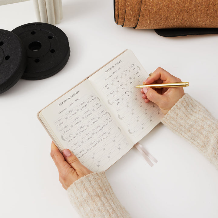 Beige progress journal for achieving fitness and health goals