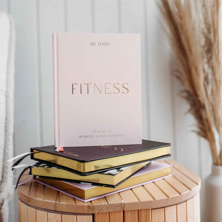 Strength training routine tracked inside a Fitness Log Book.