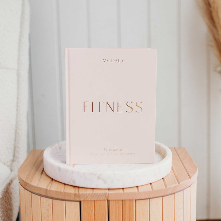 Monthly goal check-in inside a Fitness Log Book.