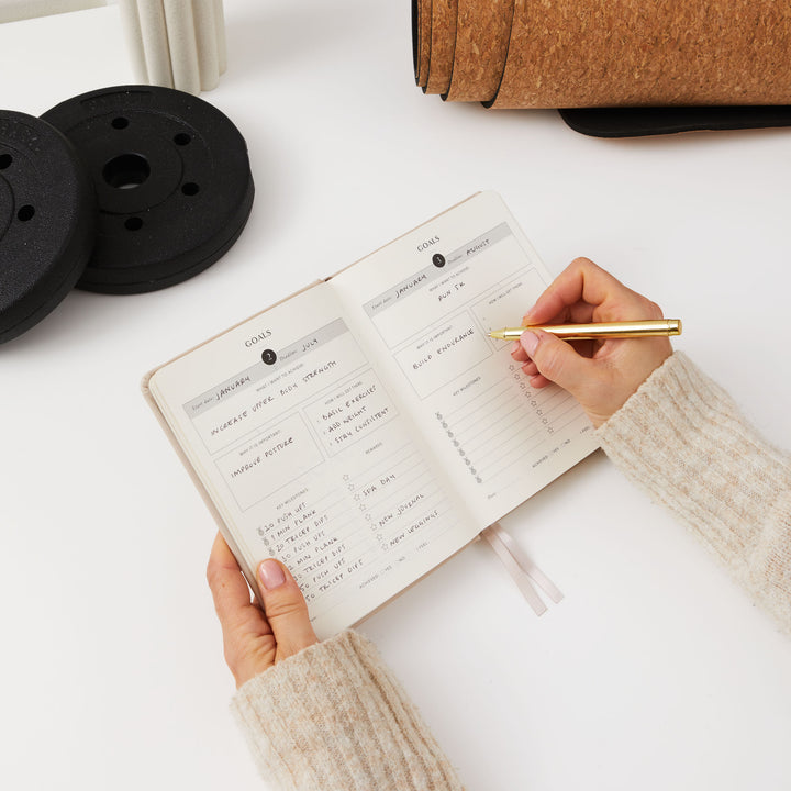 Beige-coloured progress journal for healthy lifestyle goals