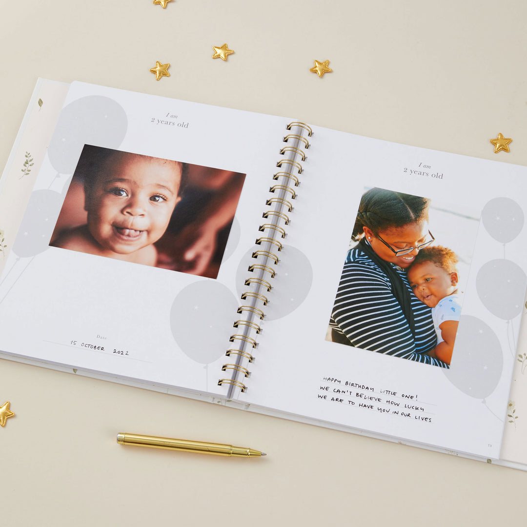 loral baby record book cover with timeless gold foil accents and elegant cloth finish.